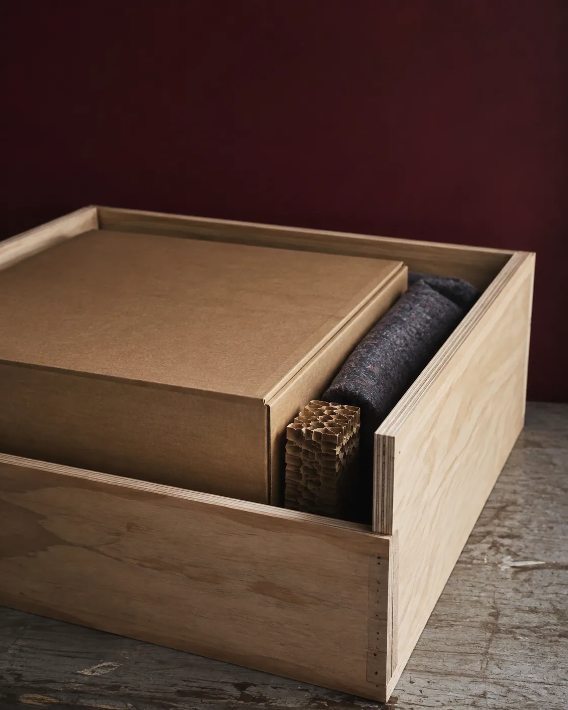 Illustrative close view of a plain carton protected inside a plywood shipping case.
